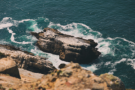 high-angle photography of rock on body of water thumbnail