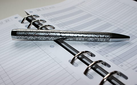 black click pen on opened binder book thumbnail