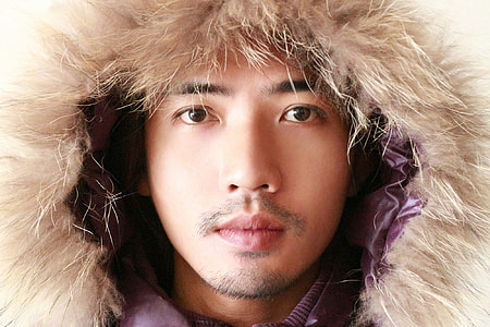 close-up photo of man wearing brown fur coat thumbnail