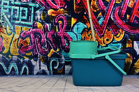 mop bucket beside graffiti wall thumbnail
