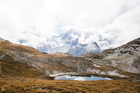 mountain covered with clouds during daytime thumbnail