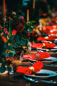 plates beside rose flowers on brown surface thumbnail