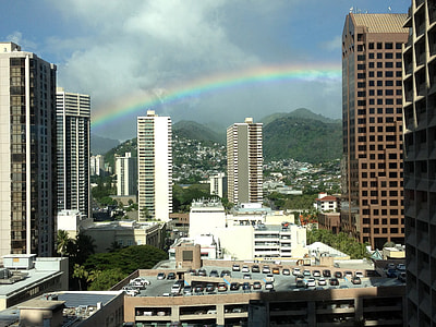 Rainbow over city buildings in Honolulu, Hawaii thumbnail