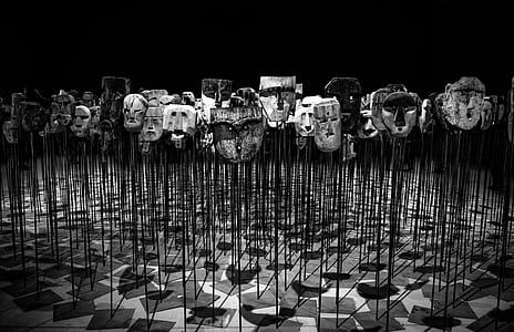 Greyscale Photo of Masks on a Stick thumbnail