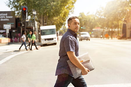 man carrying gray bag thumbnail