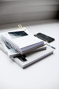 spiral notebook beside phone thumbnail