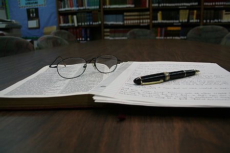 black pen beside eyeglasses on top of book thumbnail