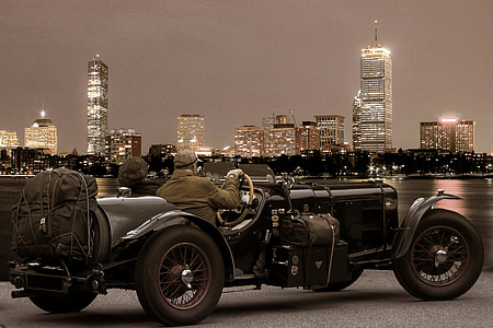 couple riding black vintage car thumbnail