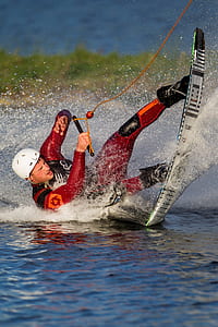 time lapse photography of man riding wakeboard on water thumbnail