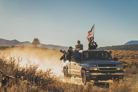 people riding silver Chevrolet Silverado in the desert thumbnail