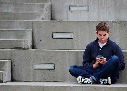 man in blue jacket sitting on concrete stair thumbnail