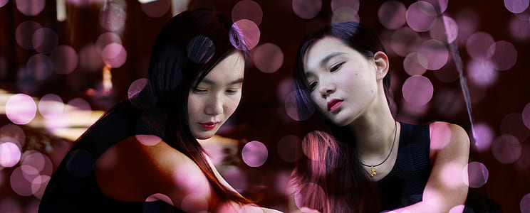 two female wearing black tops thumbnail