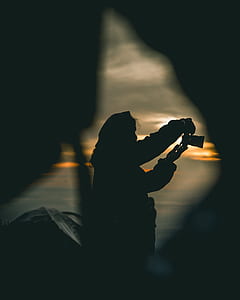 silhouette of person holding camera thumbnail