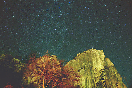 rock formation below constellation of stars thumbnail