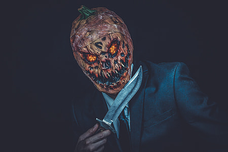 man wearing Jack-O-Lantern mask thumbnail