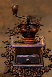 shallow focus photography of brass-colored coffee grinder thumbnail
