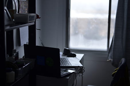 black laptop computer on desk near window inside room during daytime thumbnail