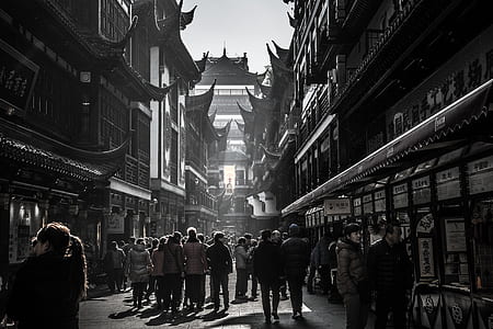 grayscale photo of people between buildings thumbnail