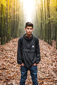 man standing in the middle of forest thumbnail