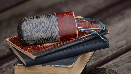 eyeglasses on piled books thumbnail