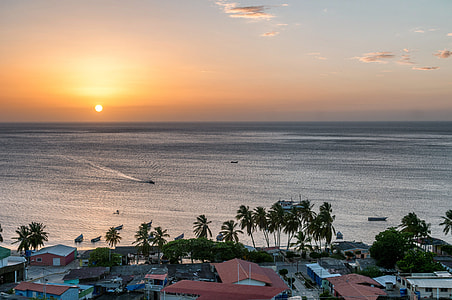 houses near body of water during sunset thumbnail