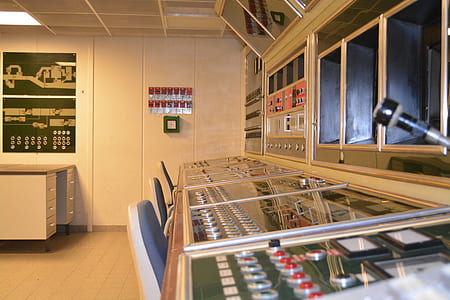 empty seat of three white chairs facing control panel thumbnail