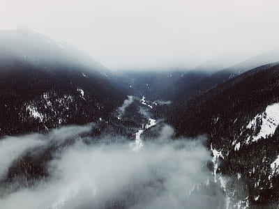 birds eye view of mountain covered with smoke thumbnail