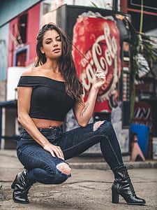 woman on road near black Coca-Cola vending machine thumbnail