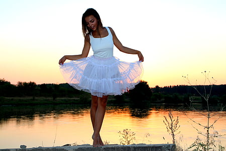 woman wearing white dress standing on gray concrete ground thumbnail