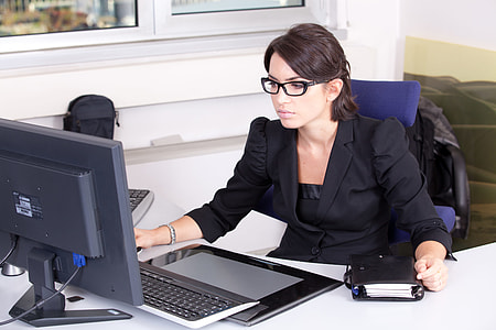 women wearing black formal suit using computer thumbnail