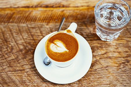 white mocha cup on white saucer plate beside drinking glass thumbnail