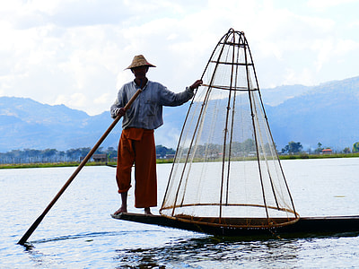 man standing on boat fishing during daytime thumbnail