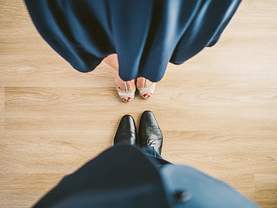man standing in front of woman on parquet flooring thumbnail