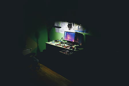 black flat screen computer monitor on white wooden table thumbnail
