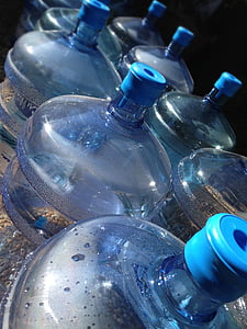 clear plastic carboy bottles on gray surface thumbnail