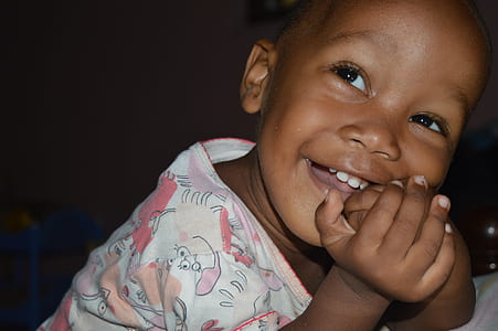 girl smiling against black background thumbnail