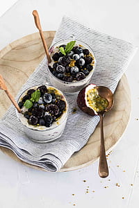 two blackberry ice creams in cups on plate thumbnail