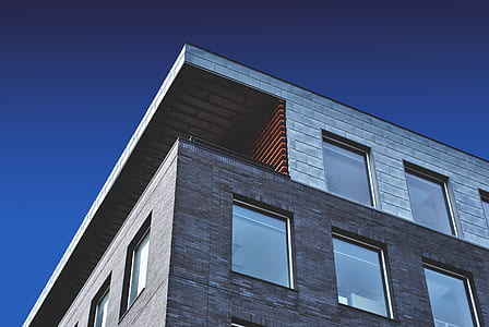 grey concrete building with glass windows thumbnail