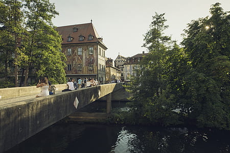 People Walking on Bridge Near the Town during Daytime thumbnail