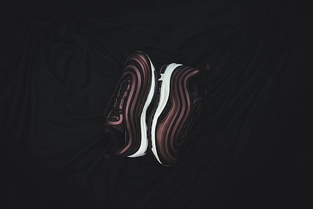 pair of brown-and-white shoes on black surface thumbnail