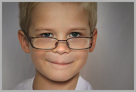 close up photo of boy wearing black eyeglasses thumbnail