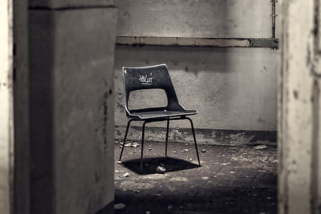 gray metal chair inside concrete room thumbnail