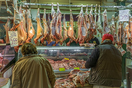 two people standing beside meat shop thumbnail