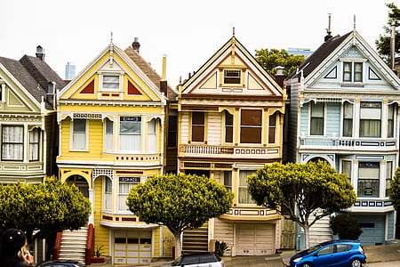 blue car parking facing houses thumbnail