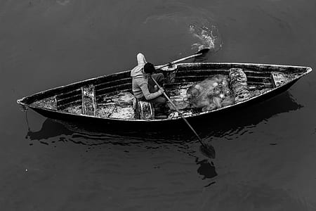 grayscale of man on boat thumbnail