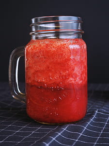 Clear Glass Mason Mug Filled With Red Liquid thumbnail