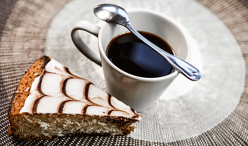 slice of cake beside cup of coffee with spoon thumbnail