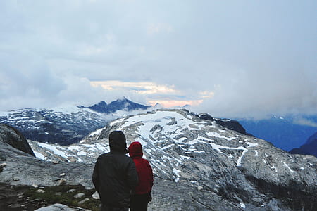 two in hoodie jackets standing and overlooking on mountain thumbnail