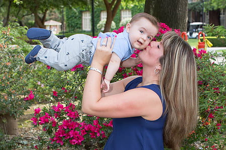 woman lifting up boy and kissing outdoor thumbnail