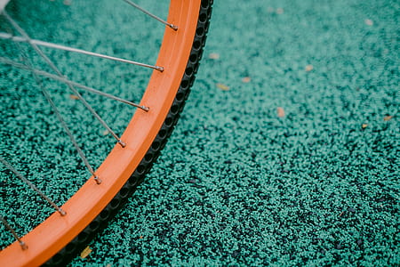 macro photography of orange bicycle wheel with tire thumbnail